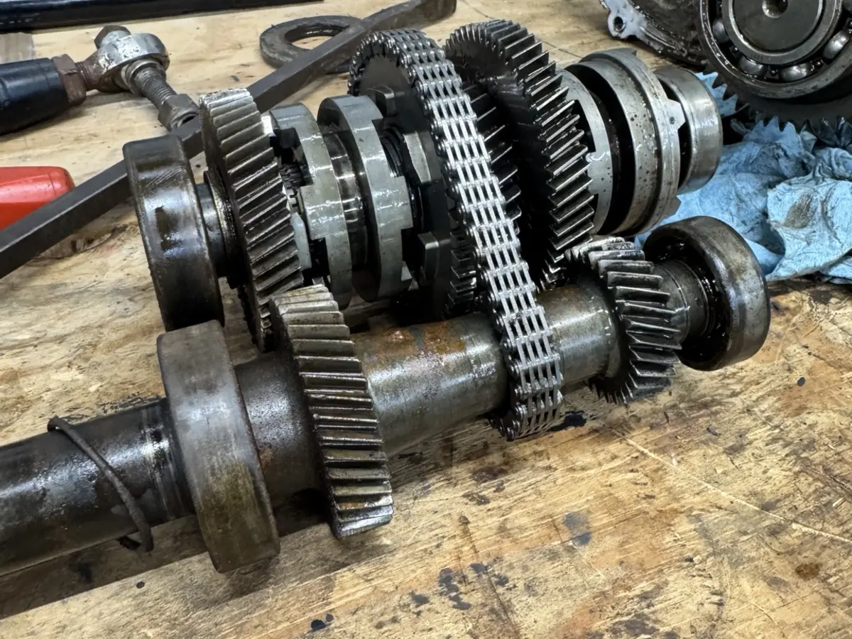 Disassembled side-by-side drivetrain components during repair