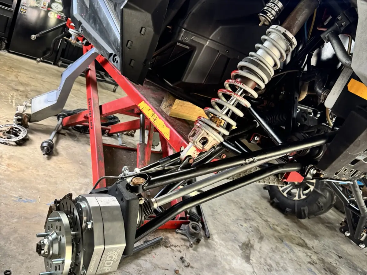 Portal gear lift and suspension components installed on a side-by-side